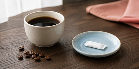 Cup of coffee beside a nicotine pouch illustrating nicotine vs caffeine
