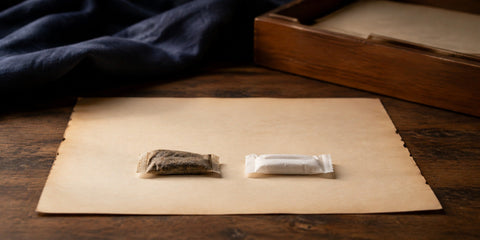 Traditional snus portion beside a modern white nicotine pouch
