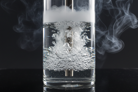 Close-up of a shisha water base with smoke passing through the water
